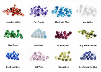 A grid of 12 small gemstone clusters labeled with months and color names, showing color options such as Garnet Red, Purple, Light Blue, White, Green, Moon opal, Ruby Red, Peridot Green, Deep Blue, Pink, Yellow, and Tanzanite Blue on a white background.