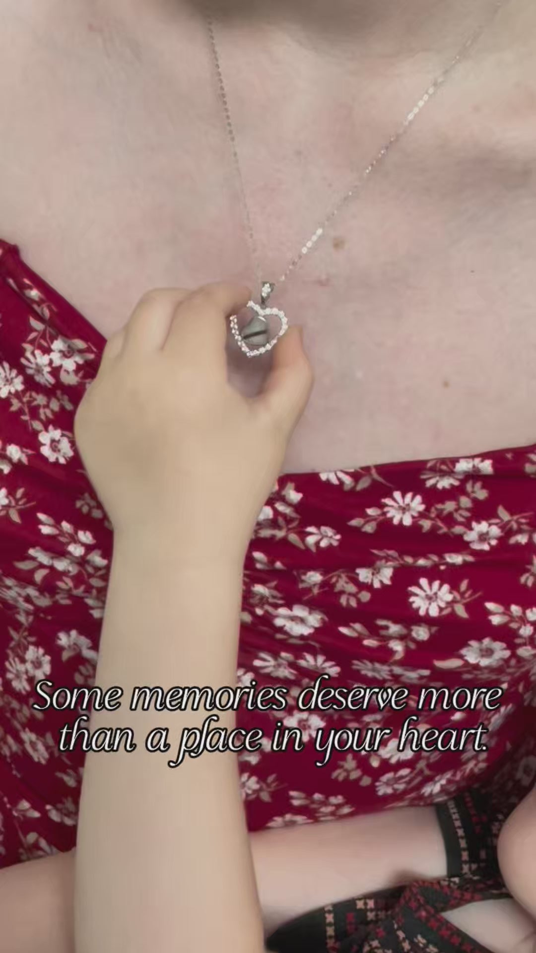 Load video: A baby holding mothers breastmilk necklace keepsake with text that says some memories deserve more than a place in your heart.