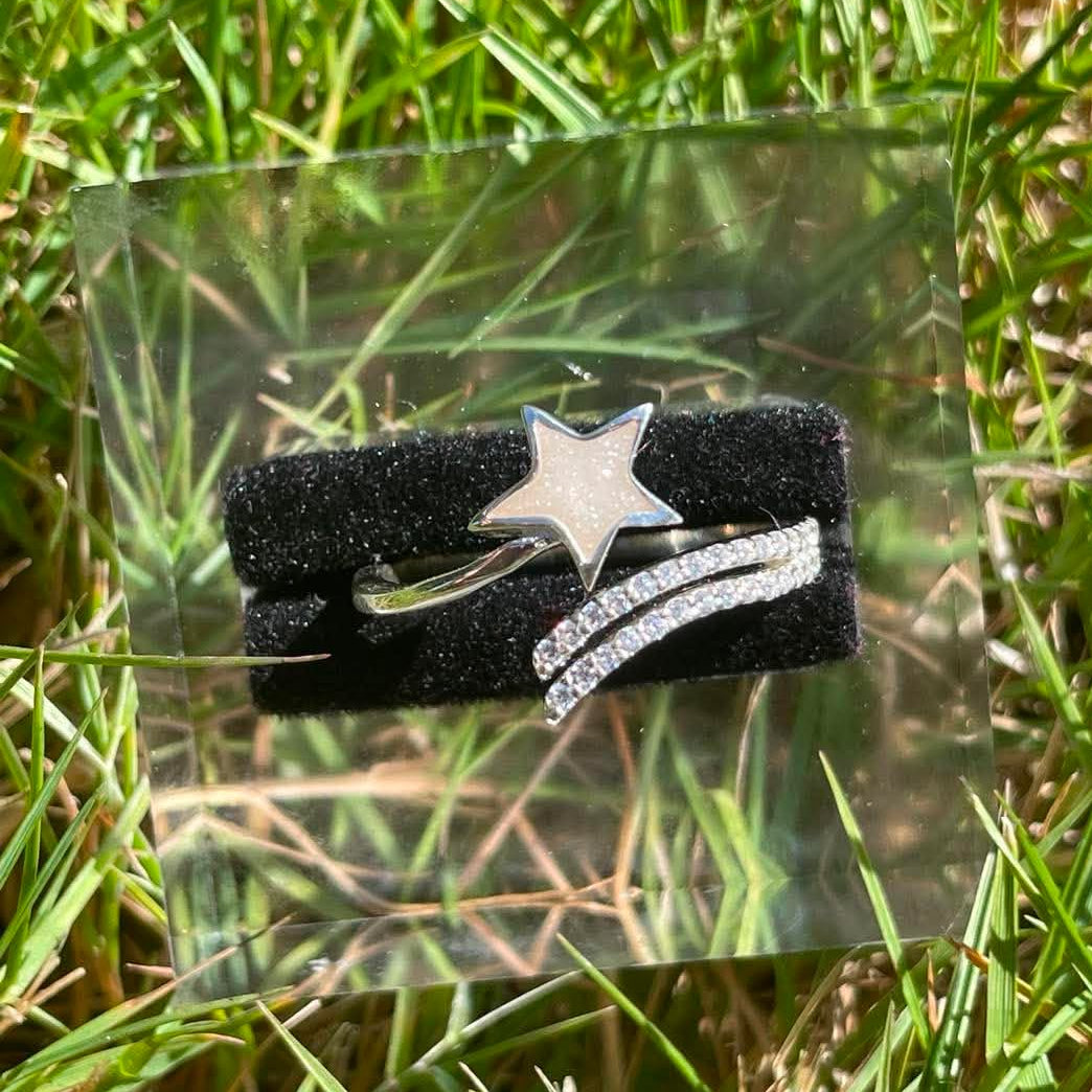 Close-up of a shooting star breastmilk ring filled with preserved breastmilk resin, featuring a delicate star-and-trail design that symbolizes the strength and love found through motherhood.